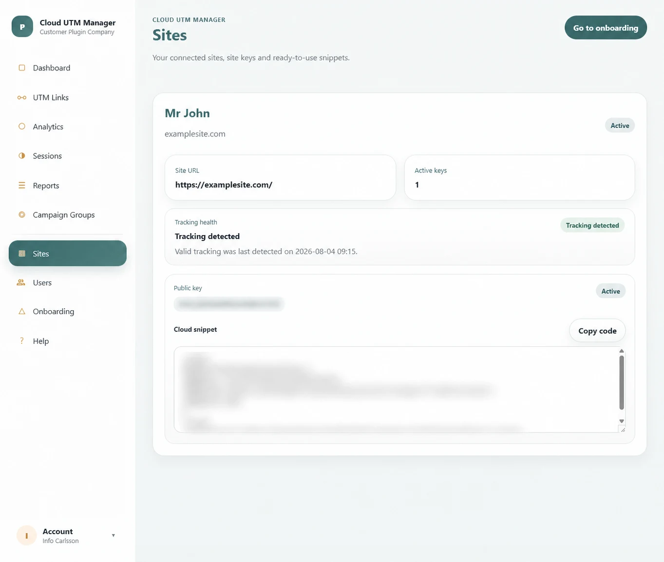 Sites page with an example domain and redacted key and snippet